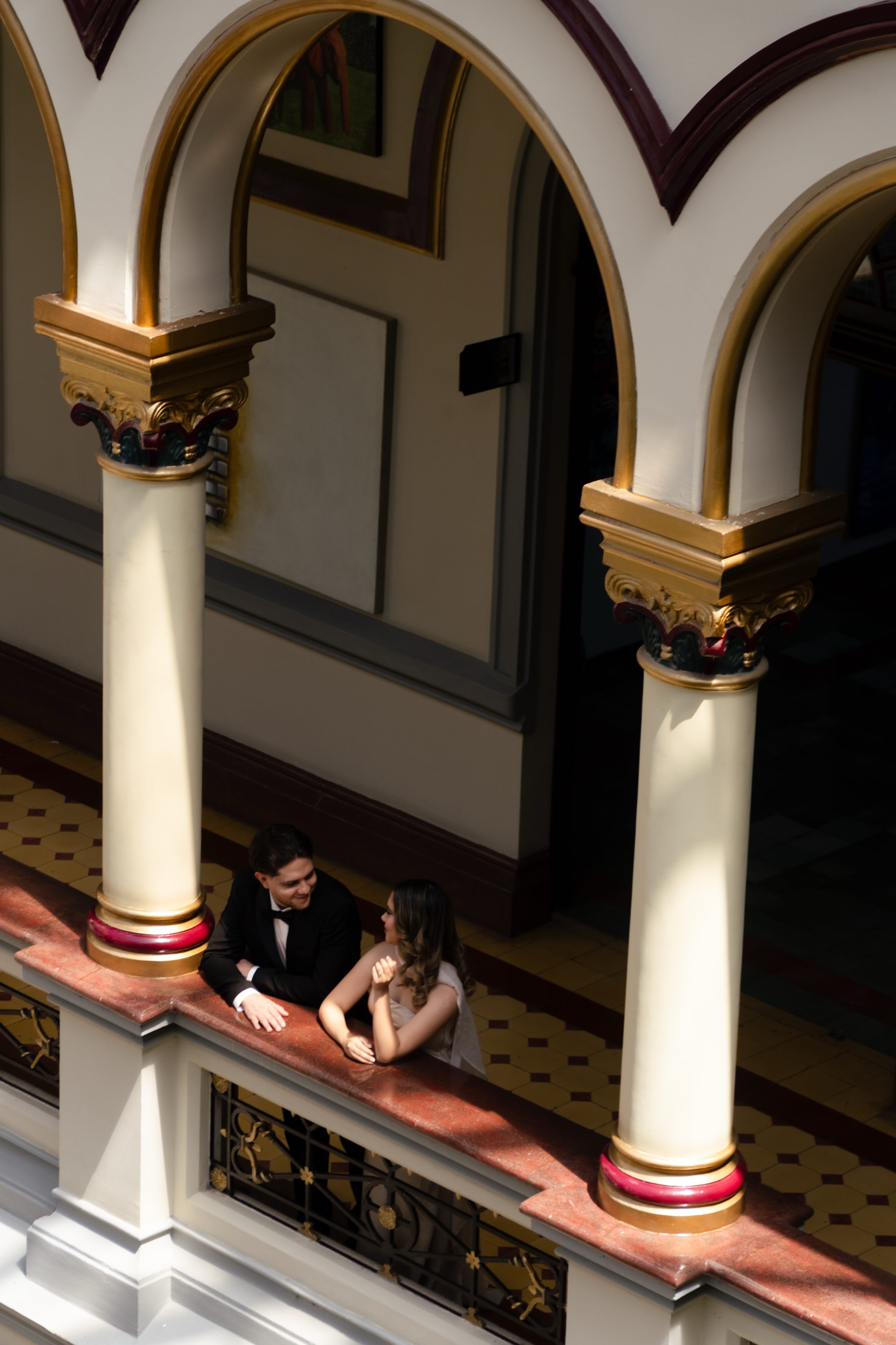 La pareja apoyada en la baranda del balcón